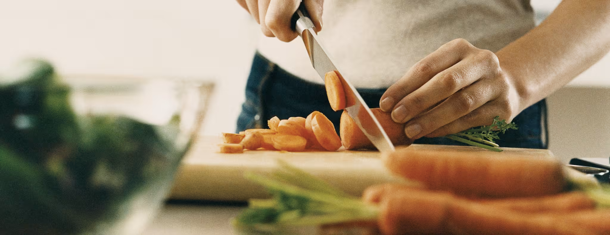 person cutting carrots