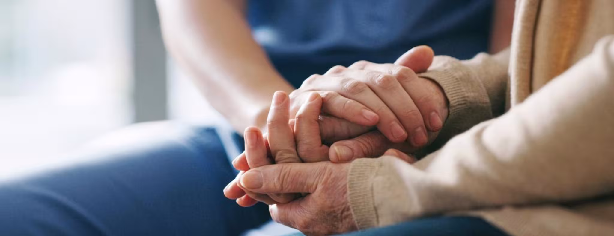 support worker holding patient hand