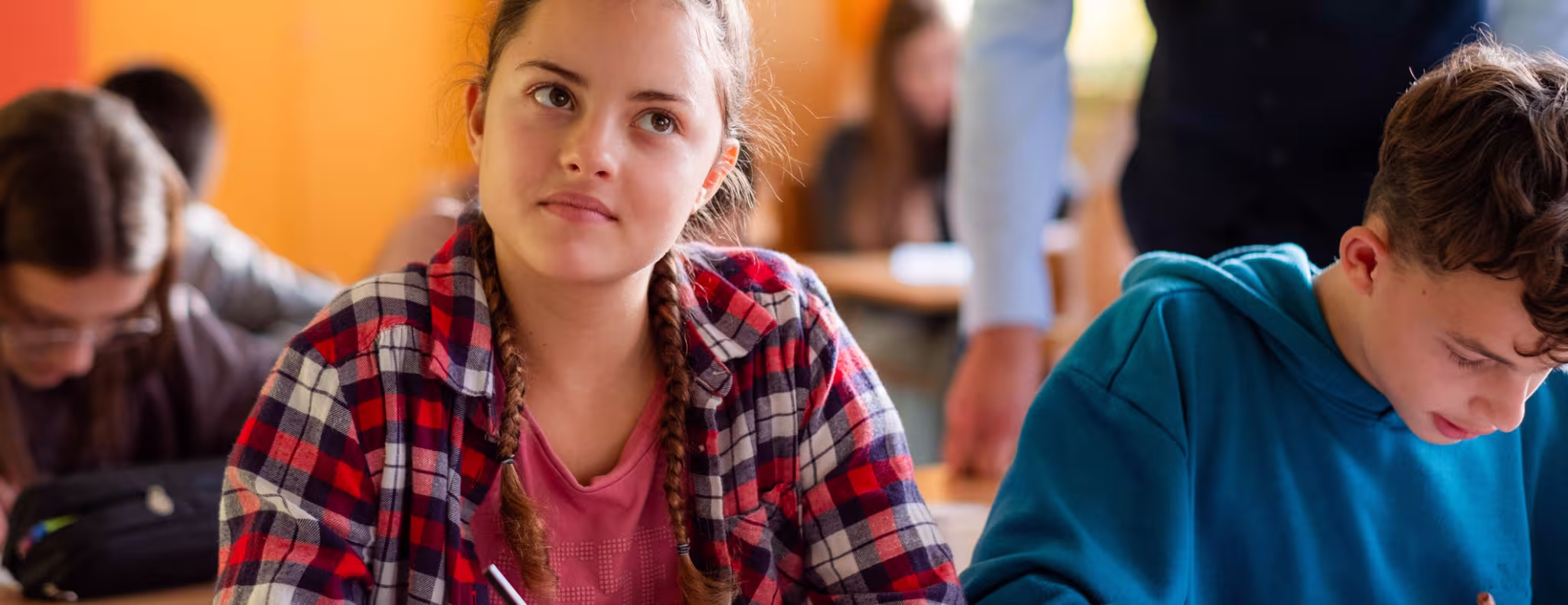 Teenager girl thinking in classroom
