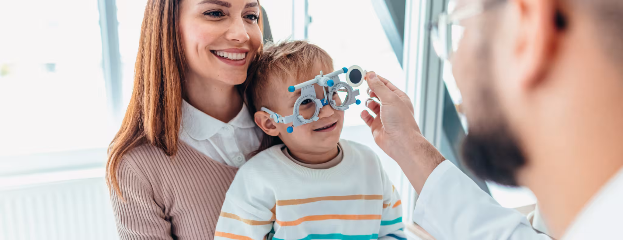 Mother and Child at Eye Appointment with an Optometrist