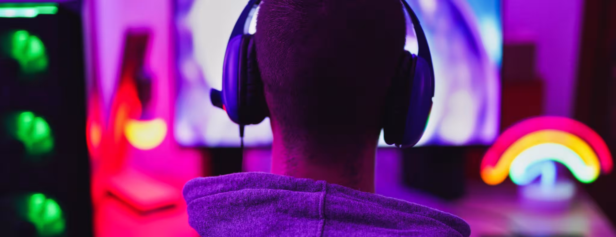 Young man wearing headset and play computer video games online