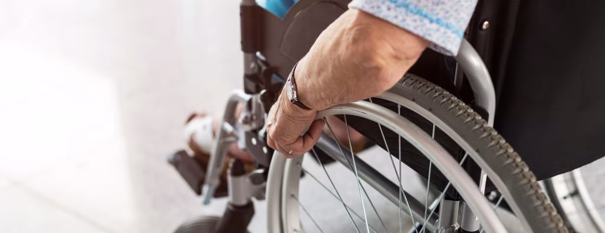 Unrecognizable senior person sitting in wheelchair