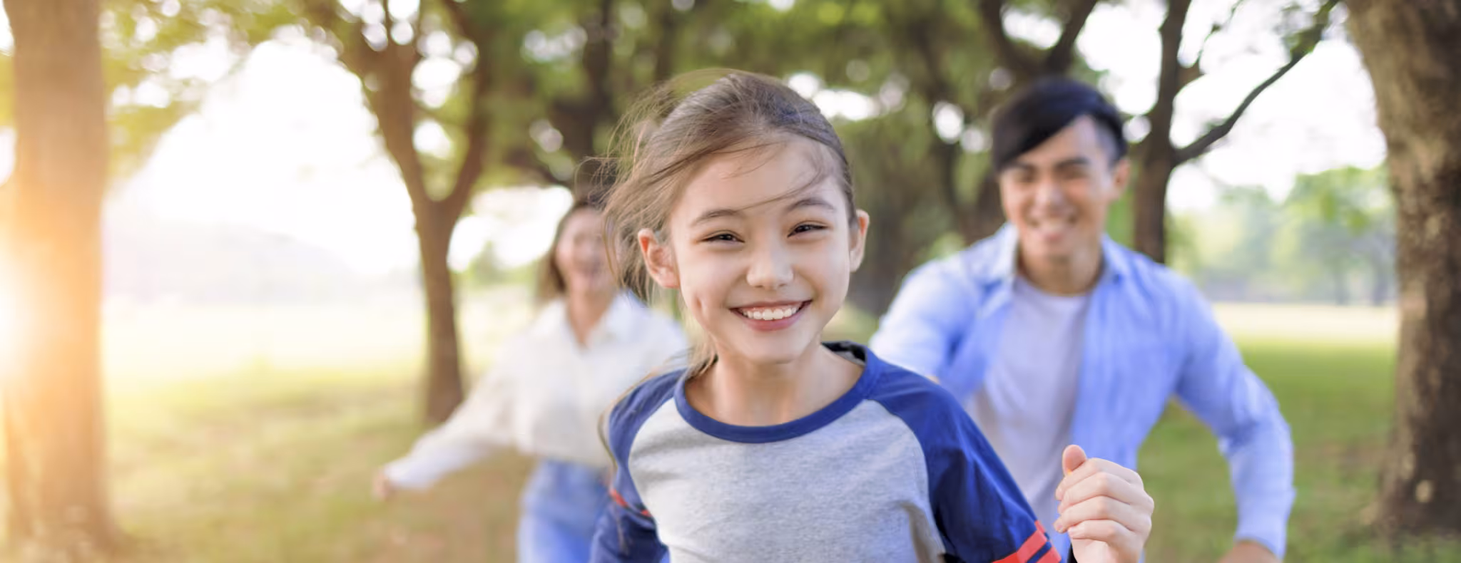 Happy Family running and playing together in the park