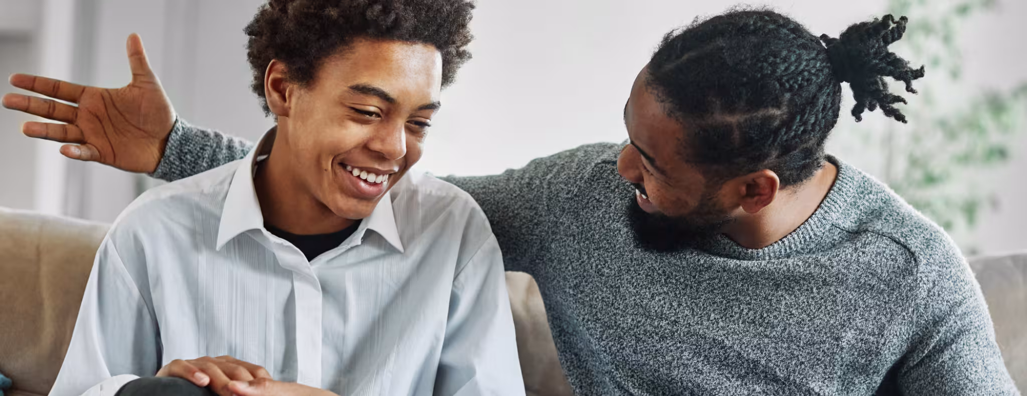 Father and teen son having a chat on the couch