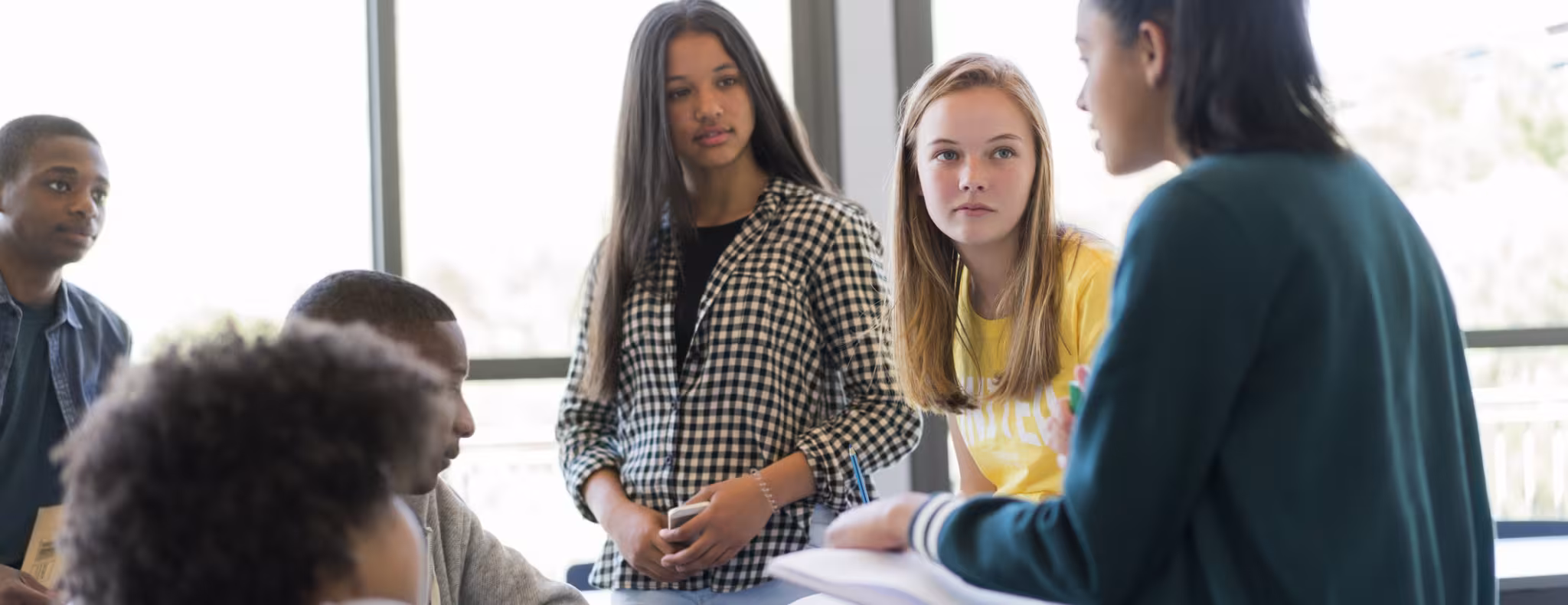 group of teens chatting in class