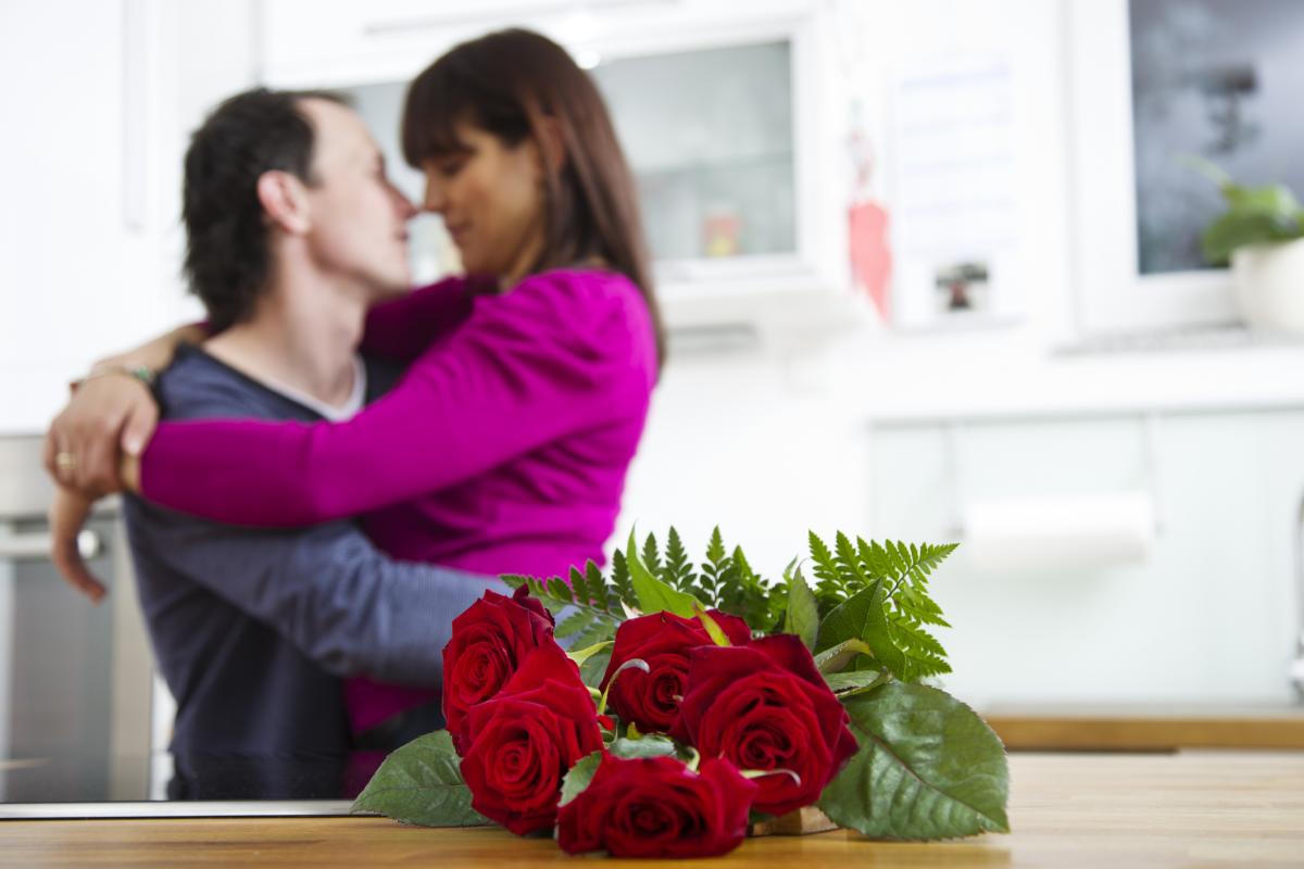 Man and woman hugging and roses